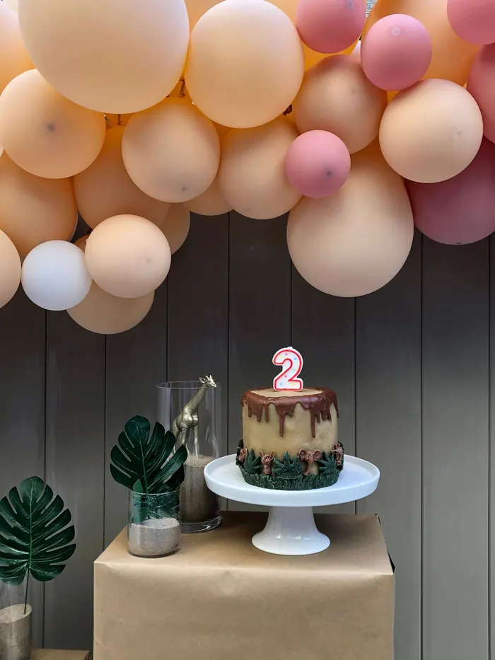 Balloons, cake stand and numbered decorations set up before the guests arrive