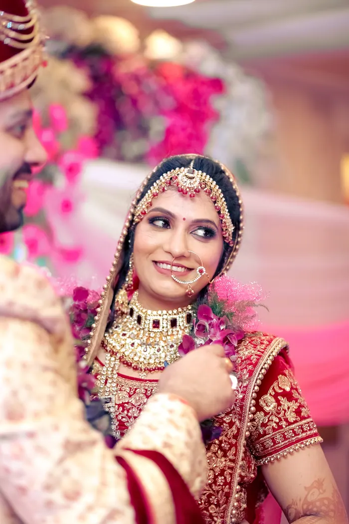 Bride laughing in full jewellery and maang tikka just before the ceremony