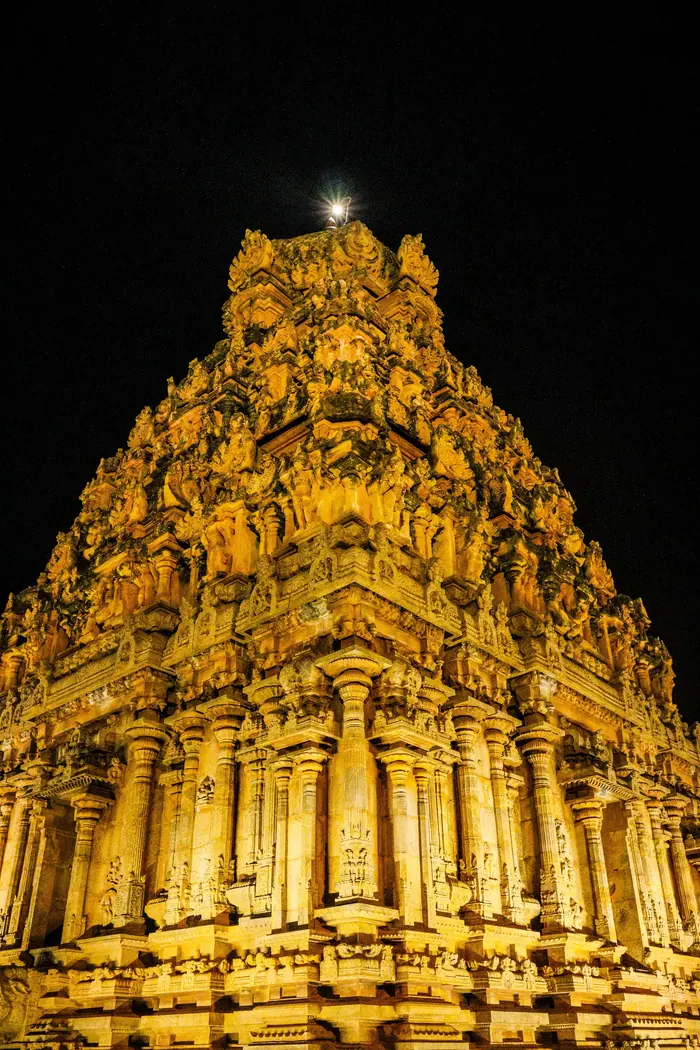 Temple lit for an evening programme, the gopuram picked out in gold