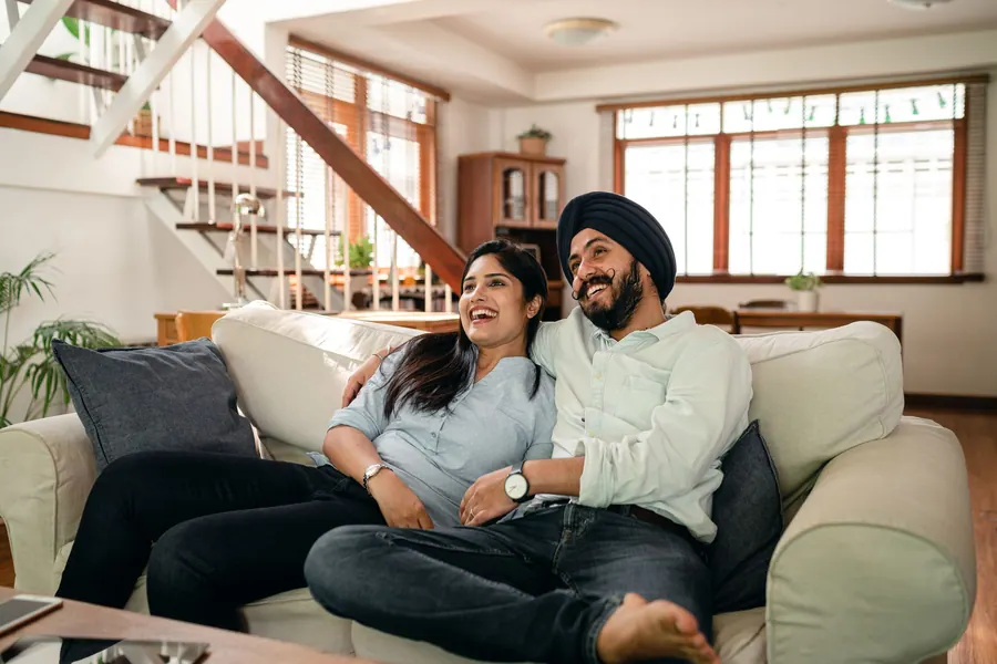 Family photographed together at home in their own drawing room