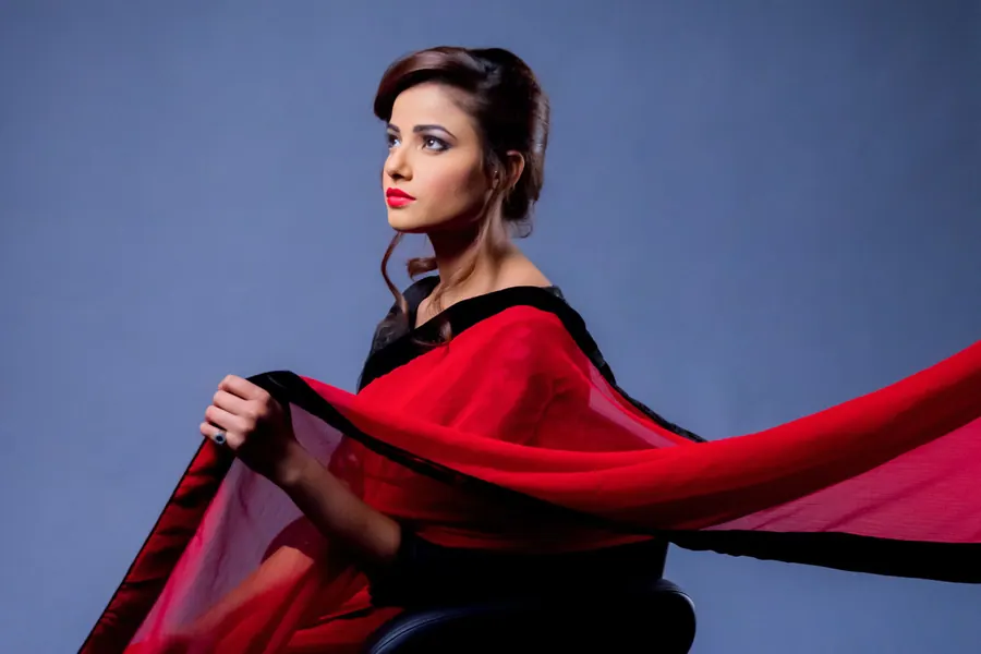 Model photographed in the studio with fabric moving through the frame