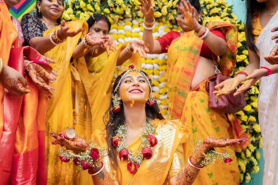 Women of the family gathered in yellow during a godh bharai