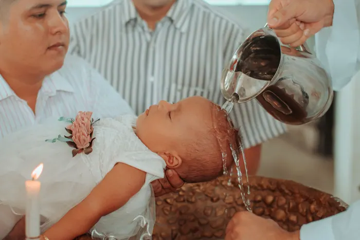 Water poured gently over a baby's head during a naming ceremony