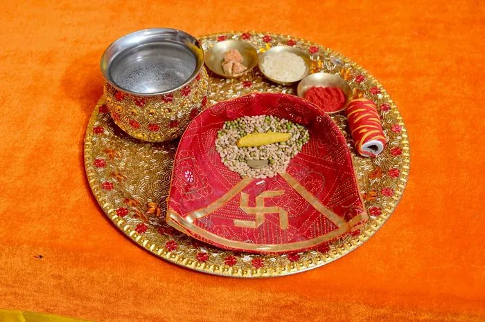 Puja thali prepared with vermilion and lamps for a baby's ceremony