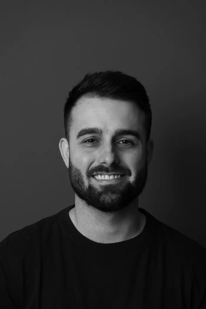 Headshot lit against a dark background for a creative profile