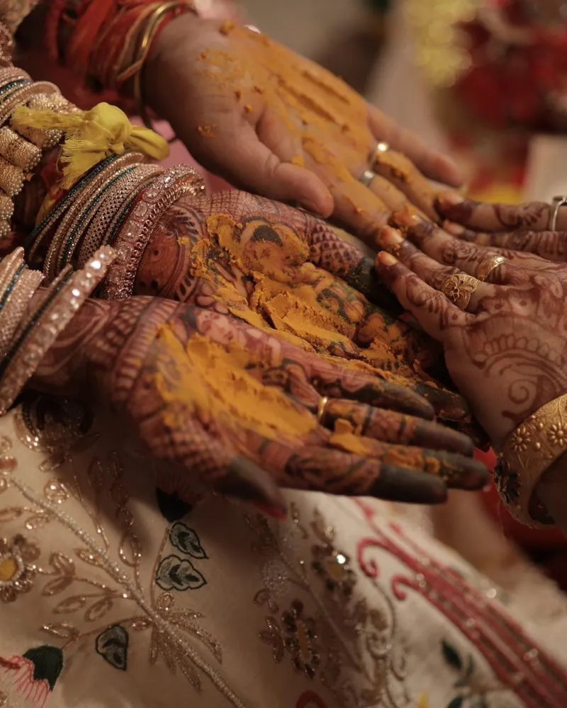 Henna covered hands and bangles resting during the mehndi