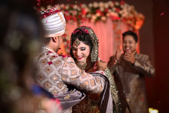Guests and family gathered around the bride during the mehndi function