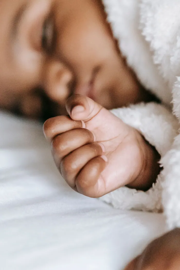 Close view of a newborn's feet cradled in a parent's hands