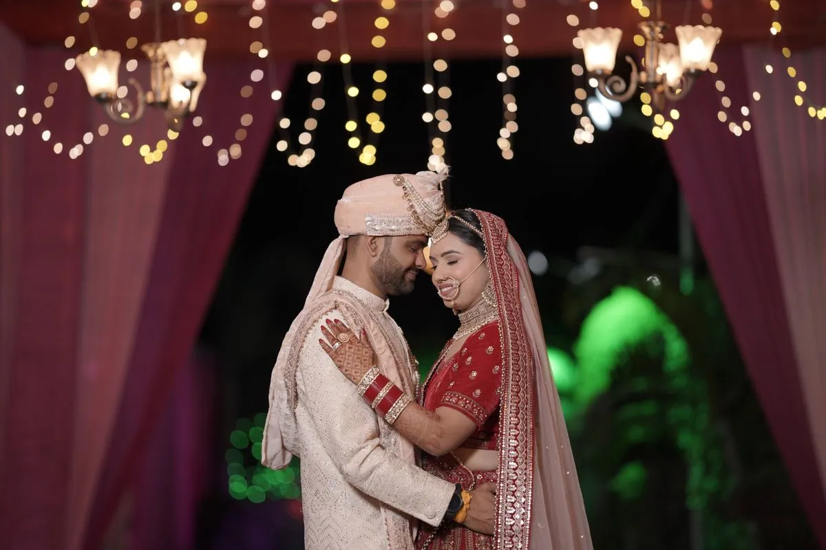 Couple photographed against evening lights during a pre-wedding shoot