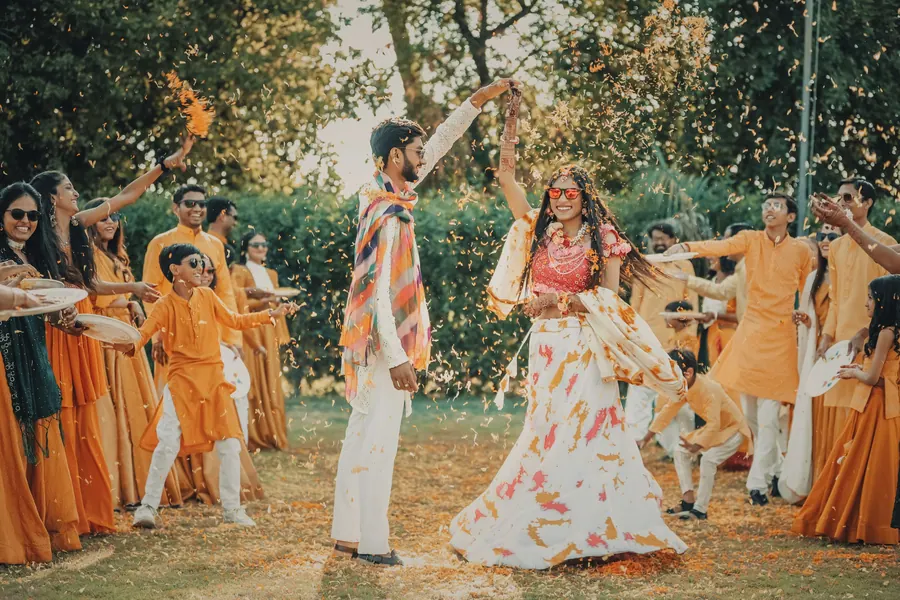 Couple dancing outdoors in the afternoon light during a pre-wedding shoot, petals in the air