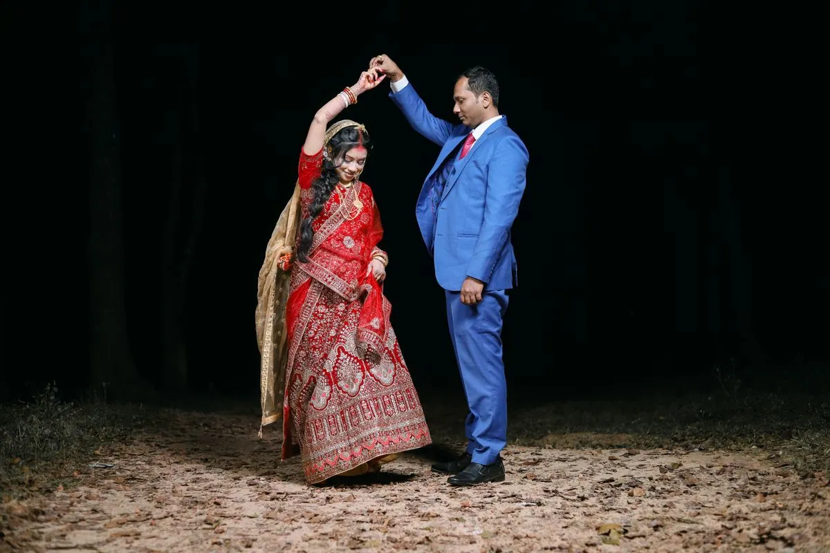 Couple dancing under the lights during the sangeet