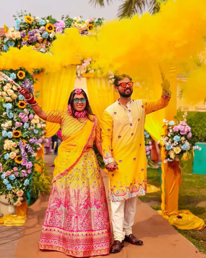 Couple dancing at the sangeet surrounded by family throwing petals