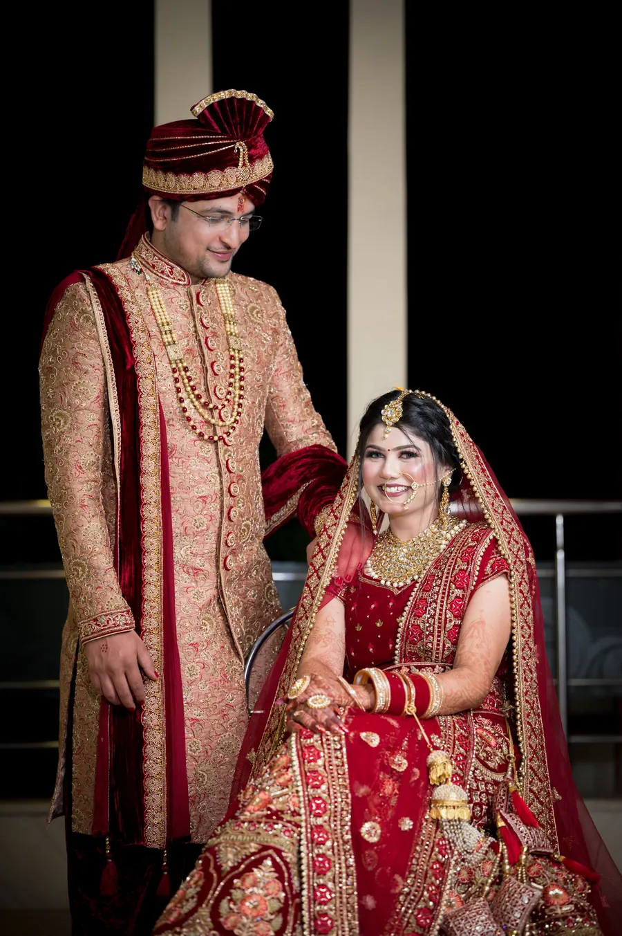 Bride and groom together after the ceremony, the bride in a red lehenga