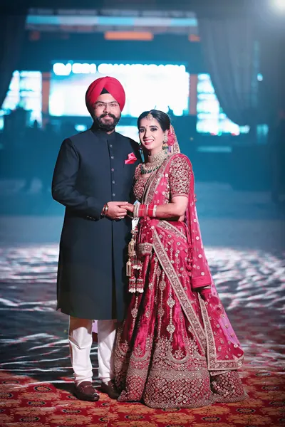 Couple photographed in a modern styled portrait, the groom in a dark suit