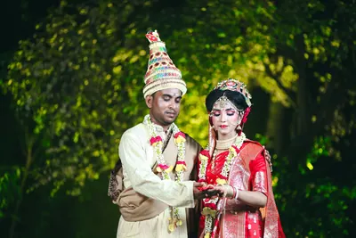 Couple in traditional dress photographed straight on during the ceremony